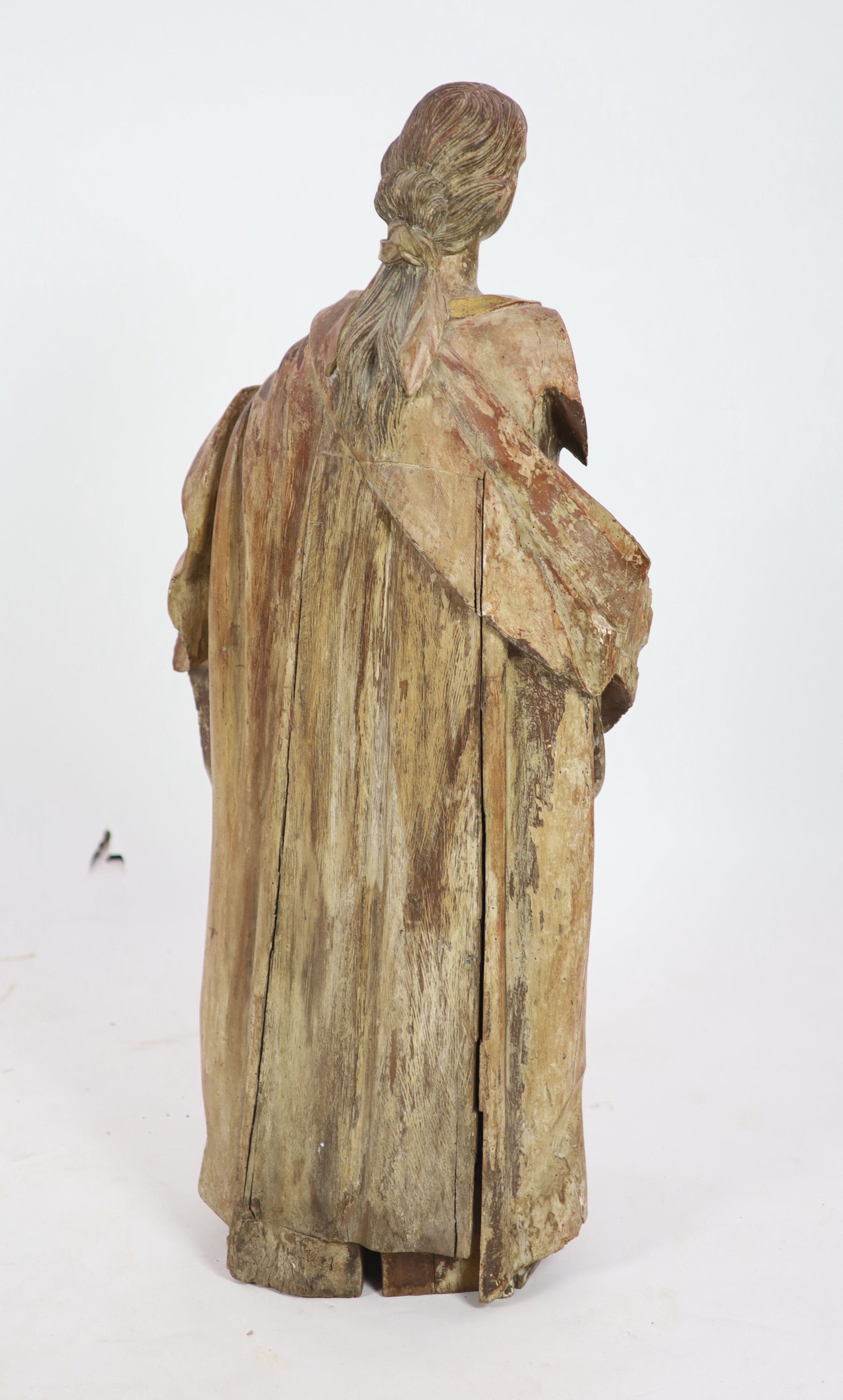 An 18th century Spanish carved wood figure of a female saint 110cm.